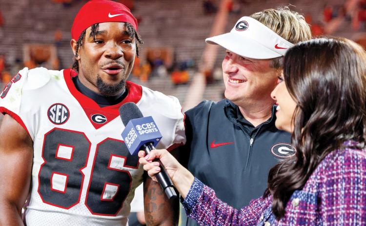 Sophomore wide receiver Dillon Bell threw a touchdown pass, caught five passes for 90 yards and a score while also recording one rush against Tennessee in Knoxville Saturday. Head coach Kirby Smart looks on with a smile during Bell’s post-game interview. COURTESY OF UGA ATHLETICS