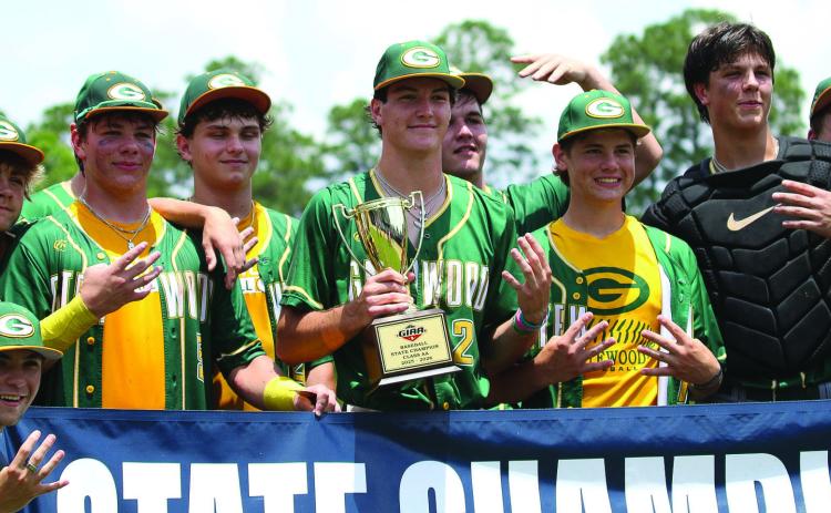 Gatewood players pose with their fourth consecutive state championship trophy last Friday in Statesboro. TREY NORRIS/Staff