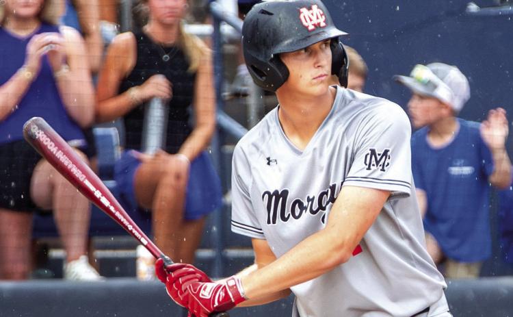 Davis Strickland braves the rain at bat during game one against Pierce County. SKYLA MORRIS/Staff