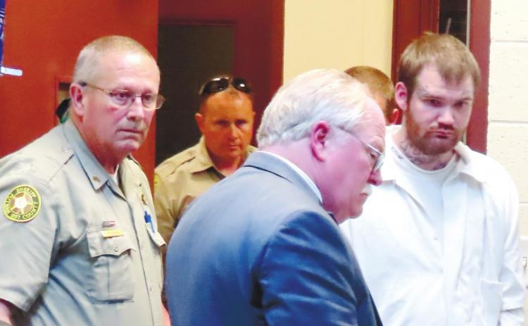No longer wearing a dress shirt and tie as he did throughout the trial, Ricky Dubose, far right, is shackled and in prison garb as he is escorted out of Putnam County Courthouse to be taken to the Georgia Department of Corrections’ Special Management Unit in Jackson. He is led by Putnam County Sheriff Howard R. Sills as well as Sgt. Bob Rogers and Deputy Chris Donovan. COURT POOL COVERAGE
