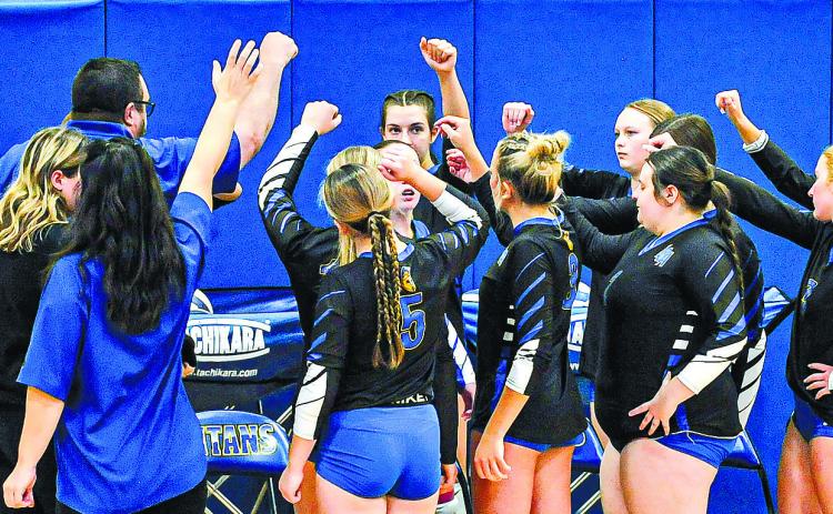 The Lady Titans circle up before one of their home matches late in the season. CHARLES JORDAN/Staff