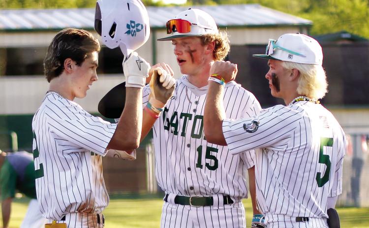 Gatewood’s Ben Brannen (2), Lawson Wooten (15), and Caleb Riser (5) celebrate after winning game one last Friday against the Warriors. TREY NORRIS/Staff