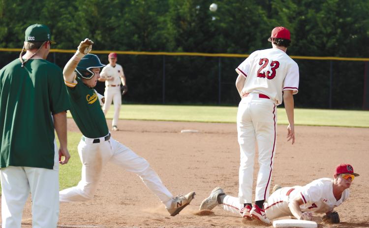 Morgan County first baseman Drew Ainslie (7) makes a dive to tag first and get the runner out in last Monday’s game against Savannah Country Day. BRENDAN KOERNER/Staff