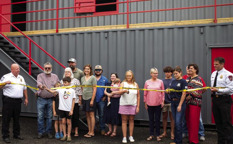 The MCFR named its new Fire Training Academy after former Morgan County Firefighters Chris Eddy, Chris McGlauchlen, and Keith Arnold. Their families cut the ceremonial ribbon on Monday morning in their honor. SKYLA MORRIS/Staff