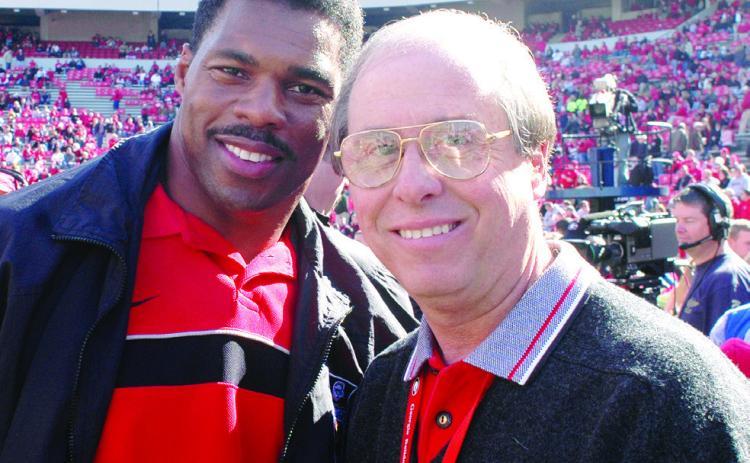 Two of the best-ever at their chosen crafts: Bulldogs’ football legend and 1982 Heisman Trophy winner Herschel Walker (left) with UGA’s legendary Sports Information and Communications Director Claude Felton on Dooley Field at Sanford Stadium in Athens. COURTESY OF UGA ATHLETICS