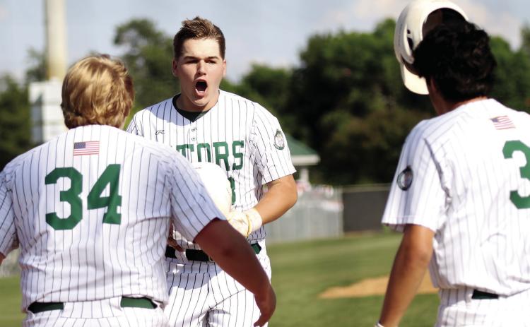 Gatewood’s Lawson Moore takes off his helmet and celebrates with teammates after hitting the second of his two home runs against Trinity Christian. TREY NORRIS/Staff