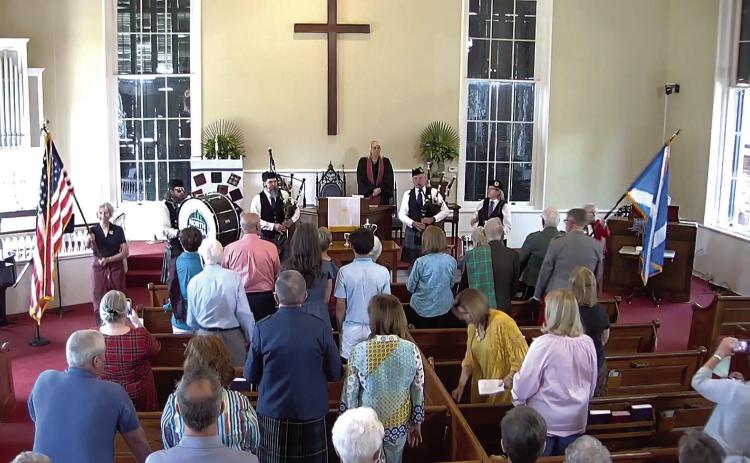 Bagpipers and drummers play a major role during the service. CONTRIBUTED