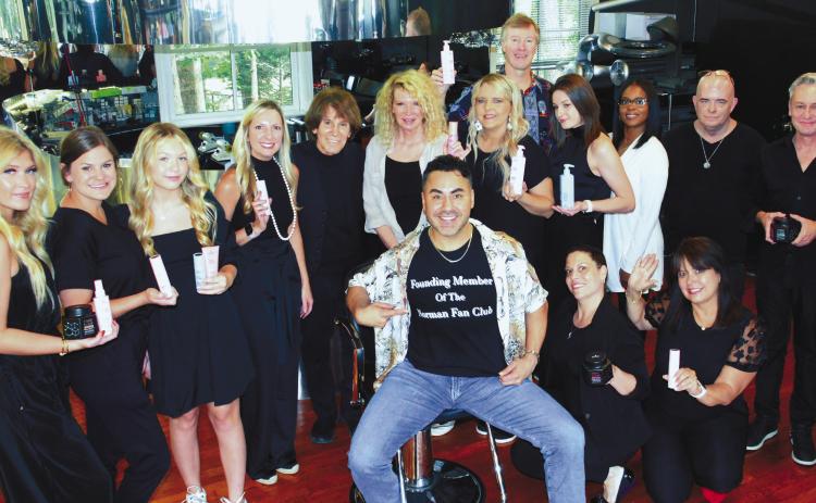 Sporting a custom-made t-shirt in honor of Zapien’s Salon founder Norman Zapien (5th from left), Carlos Rojas is surrounded by Zapien’s colorists and stylists after giving a personal demonstration June 23, of Schwarzkopf Professional’s hair coloring system. IAN TOCHER/Staff