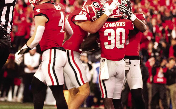 Georgia running back Daijun Edwards (30) is congratulated by teammates after one of his rushing touchdowns. He had two on the night.
