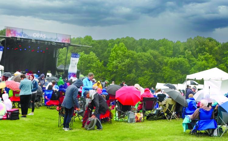 Mother Nature brought strong winds and heavy rain, which changed the program, but the show still went on as attendees huddled under umbrellas and bundled up in rain coats to brace for the elements. LEIGH LOFGREN/Staff