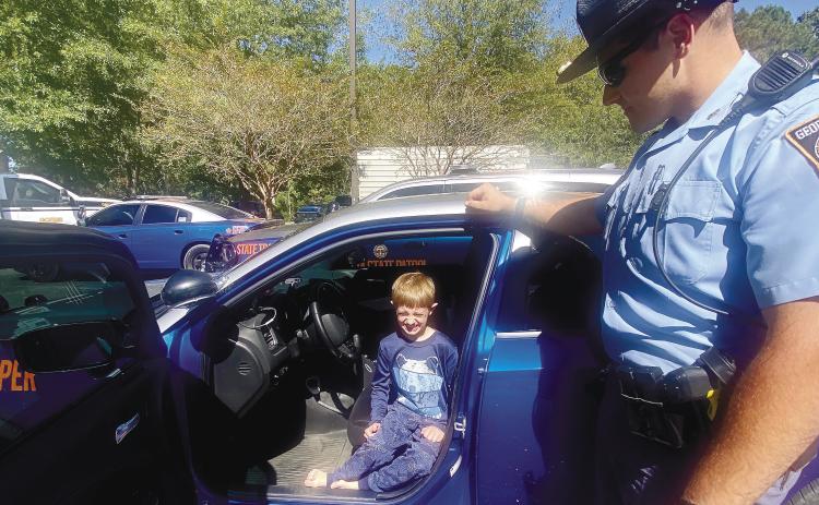 Christian Fuller, 8 years old, of Greensboro, checks out a few of the Georgia State Trooper vehicles. MAUREEN STRATTON/Staff