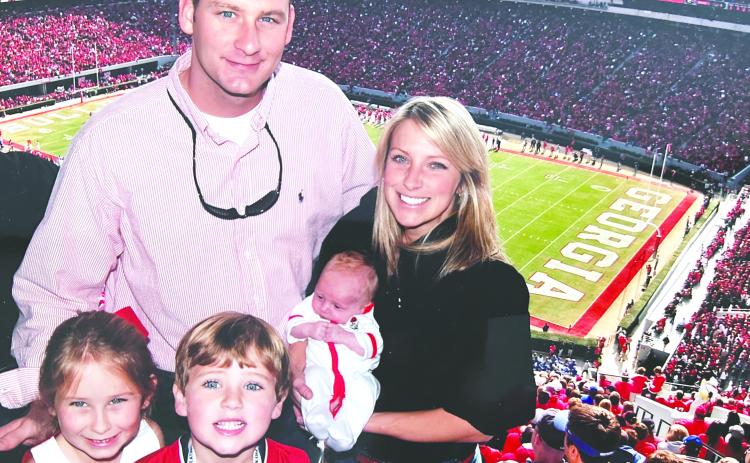 Drew Camp, a former Georgia football player and Madison resident, and his family during a Bulldogs’ game more than a decade ago. CONTRIBUTED