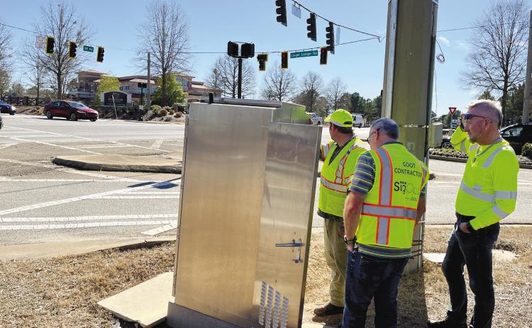 Georgia Department of Transportation workers attempt to find the right timing for new traffic lights at Highway 44 and Linger Longer Road. MARK ENGEL/Staff