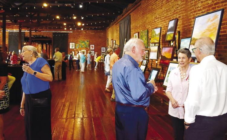 Many local art aficionados visited Barrel 118 in Eatonton to check out the art and socialize during the Juried Art Show.