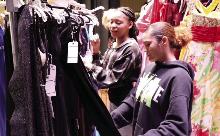 Greene County High School students peruse dresses collected by local volunteers to help provide a fairytale experience. CONTRIBUTED
