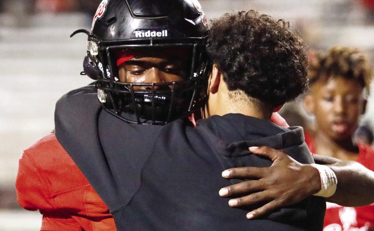 Morgan County senior running back Jay Dorsey hugs a friend after the loss. LANCE MCCURLEY/Staff