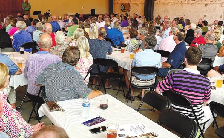 The name change was announced Tuesday night at a membership meeting held at Oconee Brewing Company. Some recipients spoke to the group about how the organization has helped their lives. MARK ENGEL/Staff