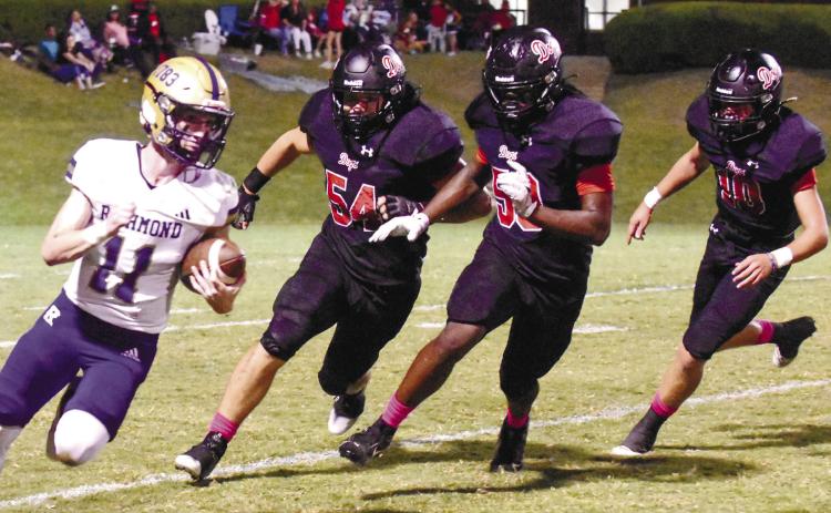 Morgan County’s Landen Vickers (54), Jamel Cox (50) and Brody Jenkins (10) chase down ARC quarterback Brooks Dickinson (11) in a 56-7 win over the Musketeers on Sept. 29. LANCE McCURLEY/Staff