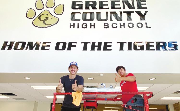 A pair of workers from 44 Signs get set to put up Greene County High School’s new ‘Ring of Honor’ wall. CONTRIBUTED