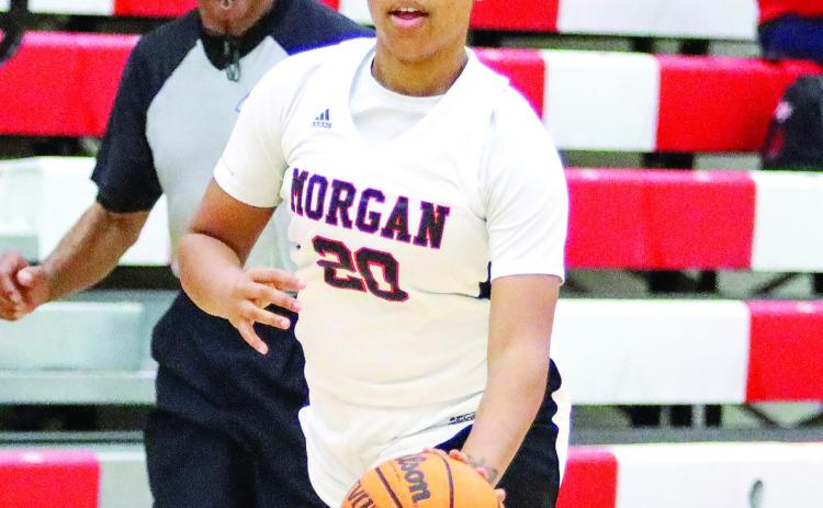 Morgan County senior Precious Benford (20) pushes the ball up the floor in a win over Salem. LANCE McCURLEY/Staff