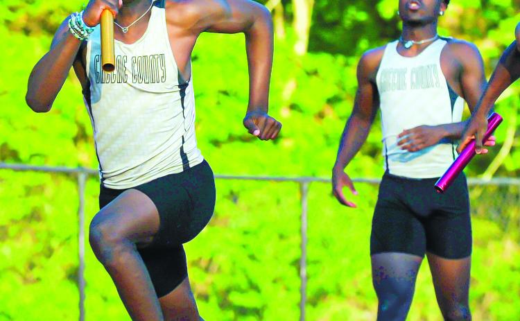 The Greene County 4X100 relay team passing the baton off between teammates. The group would place second overall at the state meet. CHARLES JORDAN/Contributed