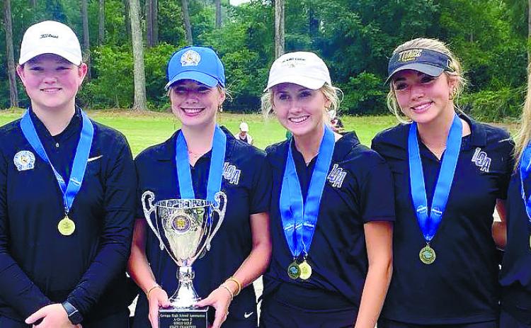 The Lake Oconee Academy girls golf team raised its third straight state championship trophy after winning the GHSA Class A Division II title. CONTRIBUTED