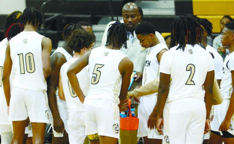 The Tigers gather during a huddle in a game against Talitaferro County earlier this season. LANCE MCCURLEY/Staff