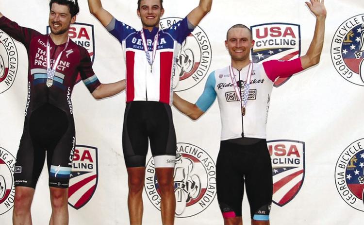Senoia’s Caleb Landgrebe, winner of the criterium race in the Georgia State Championships last Saturday in Eatonton, stands between second-place finisher Jos Chalmers (left) and third-place Forrest Howard. CALEB LANDGREBE/Photo courtesy Facebook