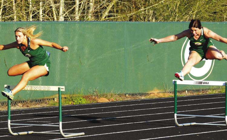 Seniors Anna Williamson (left) and Madison Hevesy (right) compete for Gatewood in the girls’ 300-meter hurdles, with Hevesy (right) finishing second while Williamson placed third. IAN TOCHER/Staff
